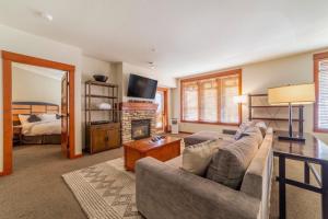 a living room with a couch and a fireplace at #535- Village, Walk to Gondola, Restaurants, and Shops in Mammoth Lakes