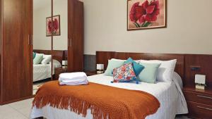a bedroom with a large bed with an orange blanket at Casa Fenteira in Poio