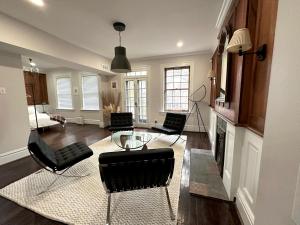 a living room with black chairs and a fireplace at CWE Luxury La Maison Modern in Tower Grove