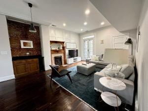 a living room with a couch and a fireplace at CWE Luxury La Maison Modern in Tower Grove