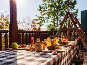 a picnic table with food and drinks on a deck at Grand Mountain View Lodge By Ghosal Luxury Lodging in Sevierville