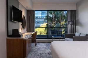 a hotel room with a bed and a large window at Radisson Hotel Cape Town Foreshore in Cape Town