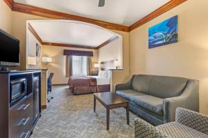 a hotel room with a couch and a bed at Best Western Fort Worth Inn & Suites in Fort Worth