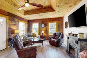 a living room with leather furniture and a fireplace at Piney Hollow - Unit B in Hendersonville