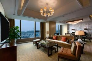 a living room with a couch and a table at Kempinski Hotel Xiamen in Xiamen