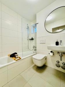 y baño con aseo, lavabo y ducha. en 3BR stay close to Allianz Arena and Munich Airport en Oberschleißheim