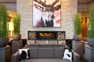 a living room with a couch and a fireplace at Kempinski Hotel Das Tirol in Jochberg