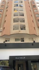 a tall building with balconies on the side of it at Résidence Ghozlane in Tunis