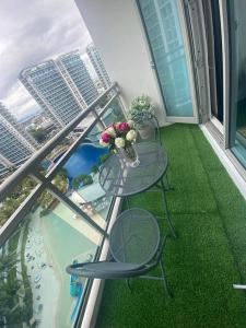 a balcony with a glass table and chairs on a balcony at Azure Beach view near airport in Manila