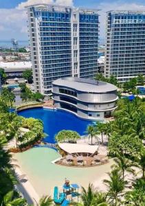 a resort with a large pool in front of tall buildings at Azure Beach view near airport in Manila