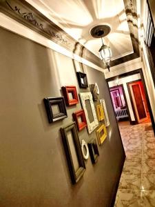 a wall with framed pictures on a wall at Luxury apartment Alexandria in Alexandria