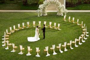 a bride and groom standing in the middle of a circle of chairs at Kempinski Hotel Fuzhou in Fuzhou