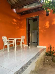 a table and two chairs in front of a house at ALOHA - PRAIA DO SONO - in Paraty