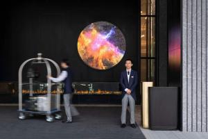 a man and a woman standing in front of a building at Kempinski Hotel Hangzhou in Hangzhou