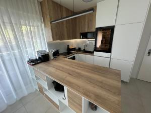 a kitchen with a wooden counter top in a room at 7 Kings Crib in Nin +11 photos