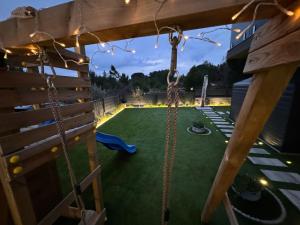 a swing in a backyard with a playground at 7 Kings Crib in Nin