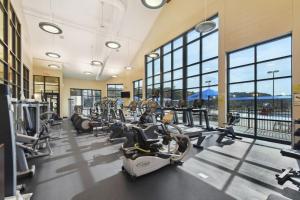 a gym with treadmills and elliptical machines at Charming Galena Townhome Near Belvedere Mansion! in Galena