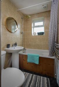 a bathroom with a sink and a toilet and a tub at Vicarage House in Blackpool