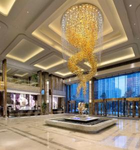 長沙市にあるKempinski Hotel Changshaの噴水のあるホテルロビーの大きなシャンデリア