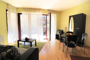 a living room with a table and a dining room at Leda Apartments in Budapest