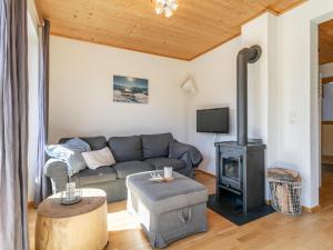 a living room with a couch and a wood stove at Hoog Hout in Hippach