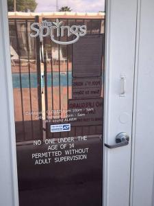 a door with a sign on the front of a building at Cozy Springs in Mesquite