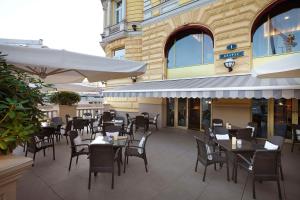 a restaurant with tables and chairs in front of a building at Hotel Baltschug Kempinski Moscow in Moscow
