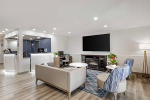 a living room with a couch and a tv at Best Western North Side Inn in Wichita Falls
