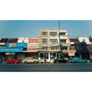 a group of cars parked in front of a building at The Memory Shop Coffee Studio X Poshtal in Lampang