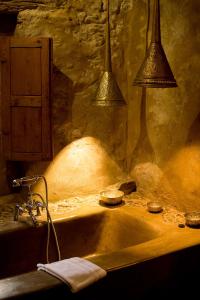 a bathroom with a sink with two lights above it at Les chambres du 7 by Juliette - Maison Caerdinael in Durbuy