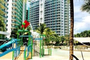 a playground in front of a large building at Azure skyview 1BR netflix karaoke ps3 Airport in Manila