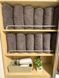 a bunch of towels are arranged in a closet at Yunseul- Garden House in the City with Korean Beauty in Seoul
