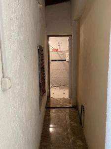 an empty hallway with an open door to a room at Tres Lunas Alojamiento Doble in Chuy