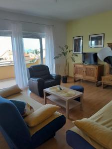 a living room with a couch and a table at Apartments with a parking space Selce, Crikvenica - 2361 in Selce
