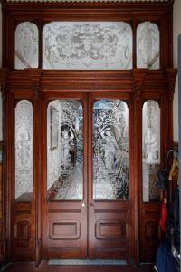 a wooden cabinet with glass doors in a room at No4 Garlands Apartment in Saint Annes on the Sea