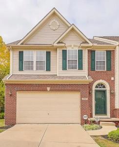 a large brick house with a garage at Condo Townhome - Cleveland Lake Area 