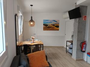 a living room with a table and a couch at Kaixo Family in Zarautz