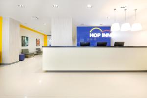 an office lobby with a top inn sign on the wall at Hop Inn Hotel North EDSA Quezon City in Manila