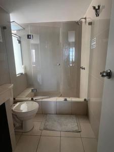 a bathroom with a shower and a toilet and a tub at Studio Apartment in Miraflores in Lima