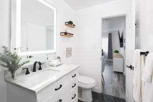a white bathroom with a sink and a toilet at 3 Bed House with Fire Pit Table and BBQ - Downtown in San Diego +22 photos