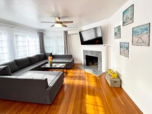 a living room with a couch and a fireplace at 2 Bedroom - Ocean View Hot Tub Parking - 8 Guest in San Diego