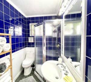 a blue tiled bathroom with a toilet and a shower at 2 Bedroom - Ocean View Hot Tub Parking - 8 Guest in San Diego
