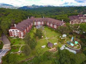 an aerial view of a large building with a yard at Private Rooms and Cabins in Camp John Hay Baguio in Baguio