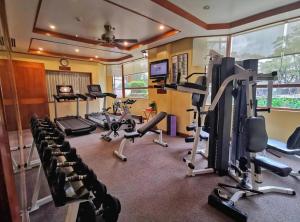 a gym with several treadmills and exercise bikes at Private Rooms and Cabins in Camp John Hay Baguio in Baguio