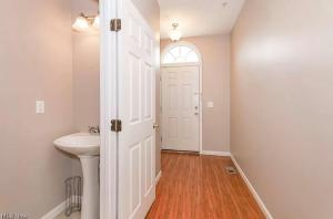 a bathroom with a sink and a white door at Condo Townhome - Cleveland Lake Area 