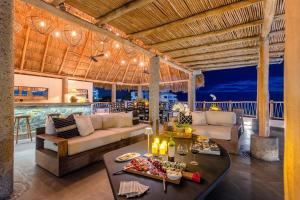 a living room with a couch and a table at NEW - Amapas Luxury 5-Bedroom Villa in Puerto Vallarta