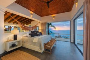 a bedroom with a bed and a view of the ocean at NEW - Amapas Luxury 5-Bedroom Villa in Puerto Vallarta +88 photos