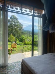 賽德曼的住宿－Lumbung ayu sari and spa，一间卧室设有一张床和一个美景窗户。