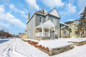 a house on a street with snow on the ground at Housepitality - The Olive - 4 BR 2 Bath in Columbus