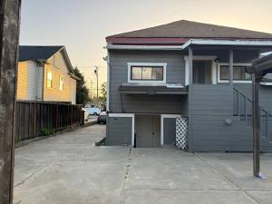 a gray house with a window and a driveway at Spacious Downtown Home SJ in San Jose
